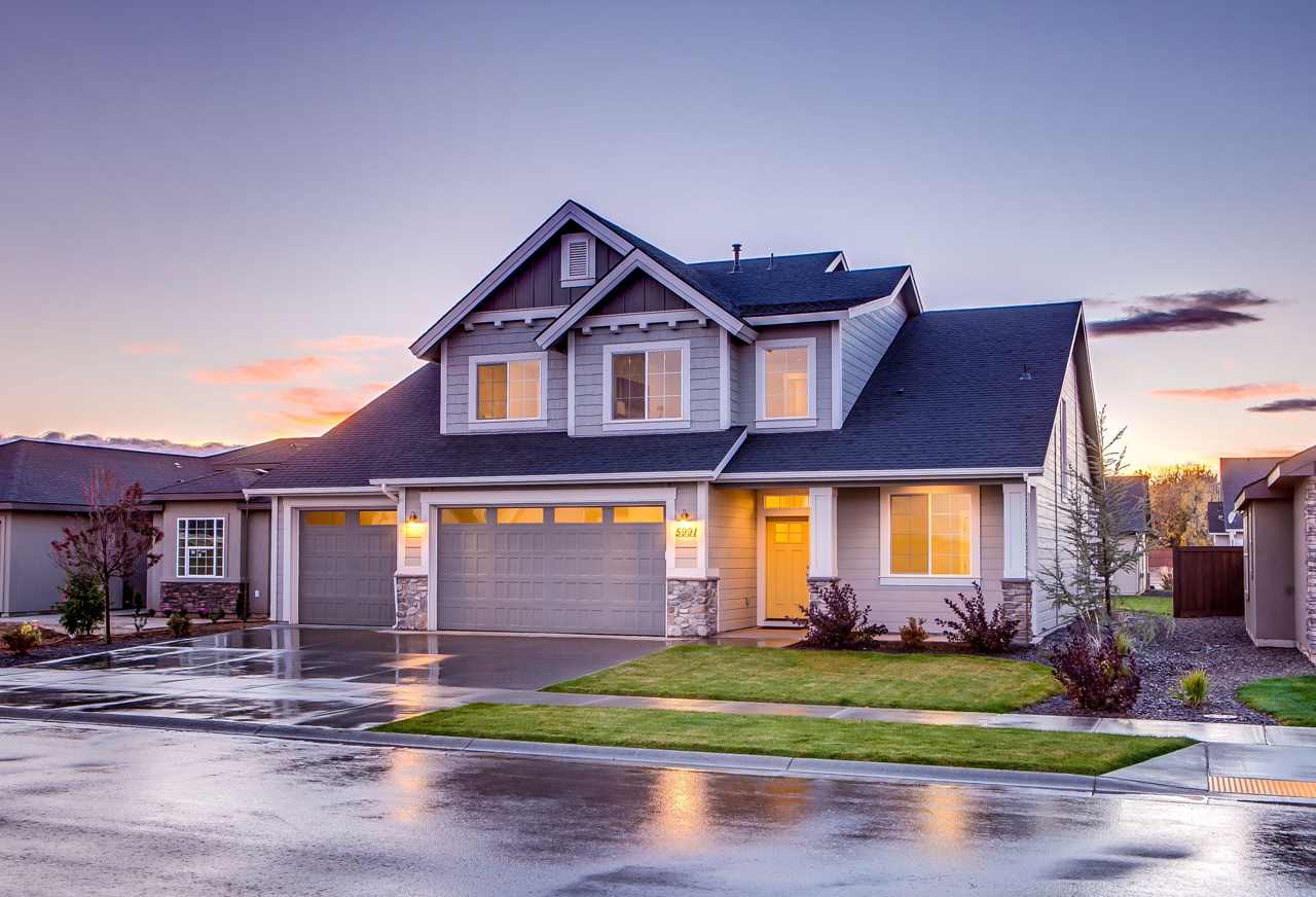 Two-story suburban home lit at dusk, typical of the Cincinnati-area homes Excalibur fits with radon mitigation systems